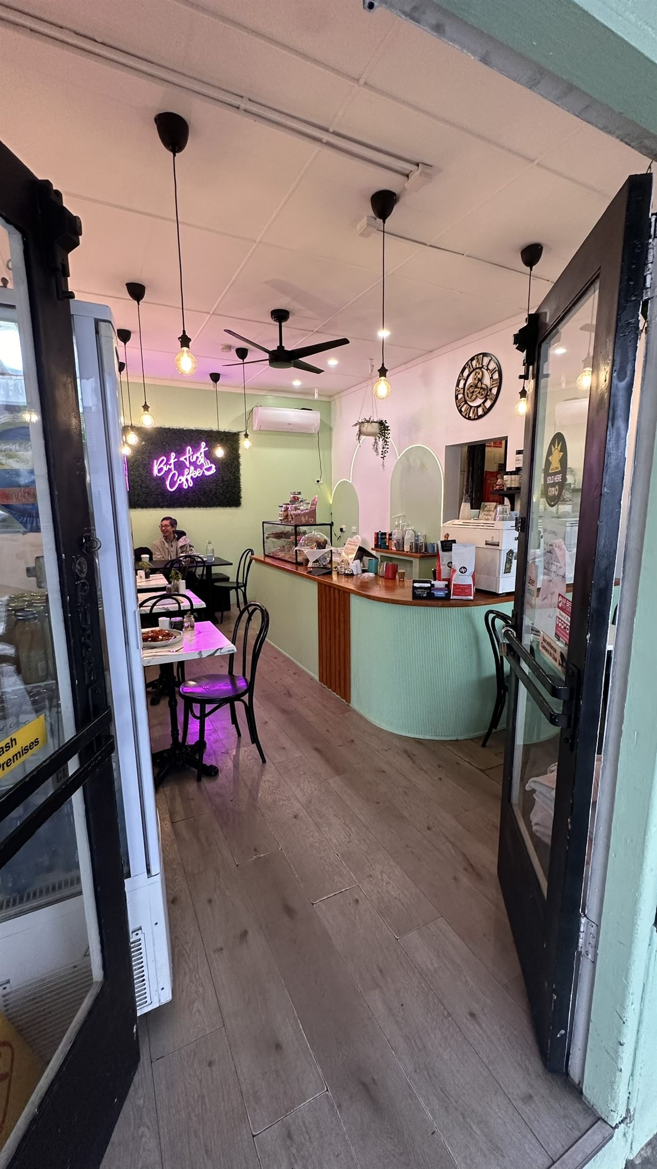 Cosy café interior with bentwood chairs and neon signage