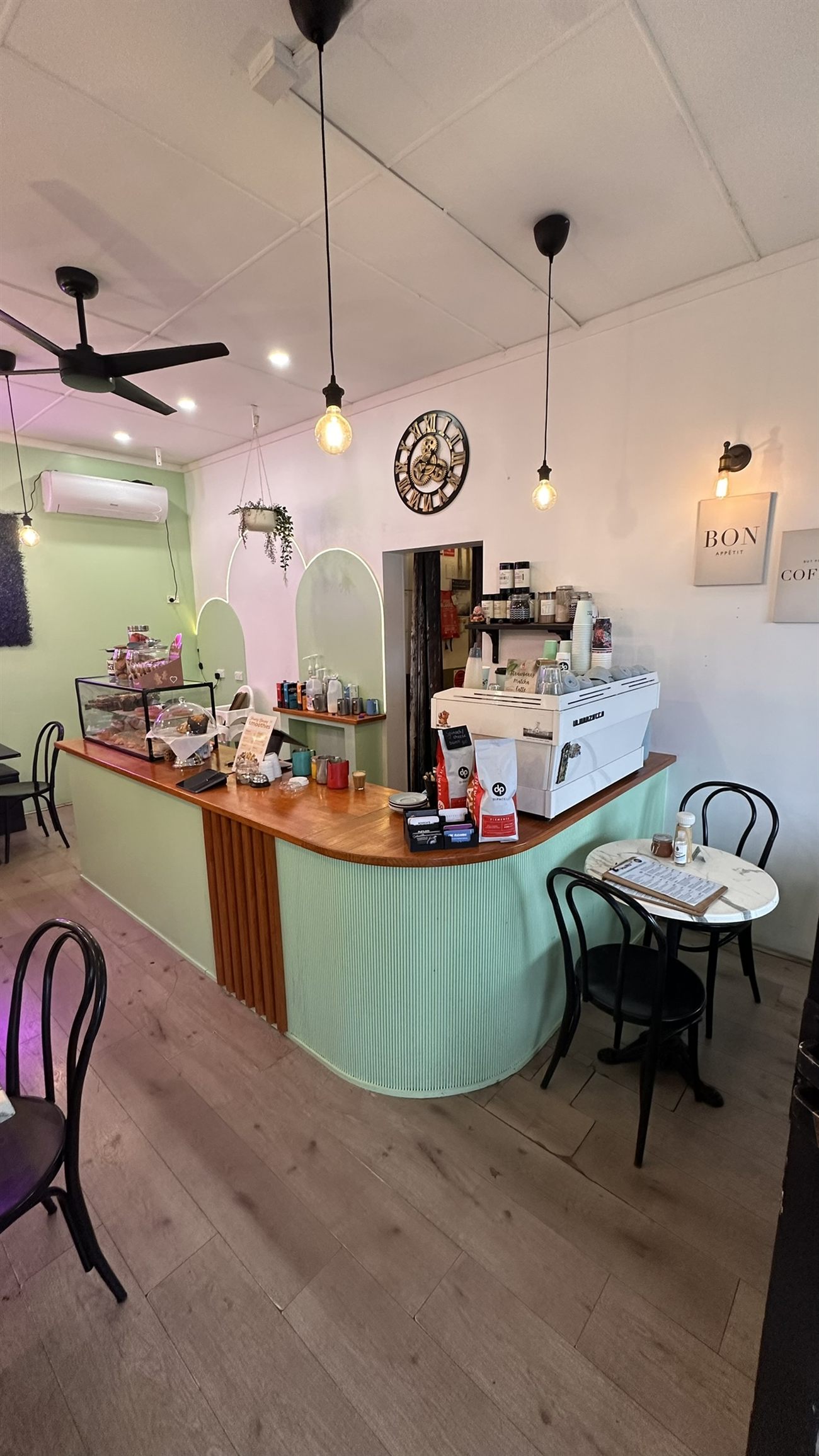 The sage-green coffee counter and espresso machine inside Culture Brew Mug